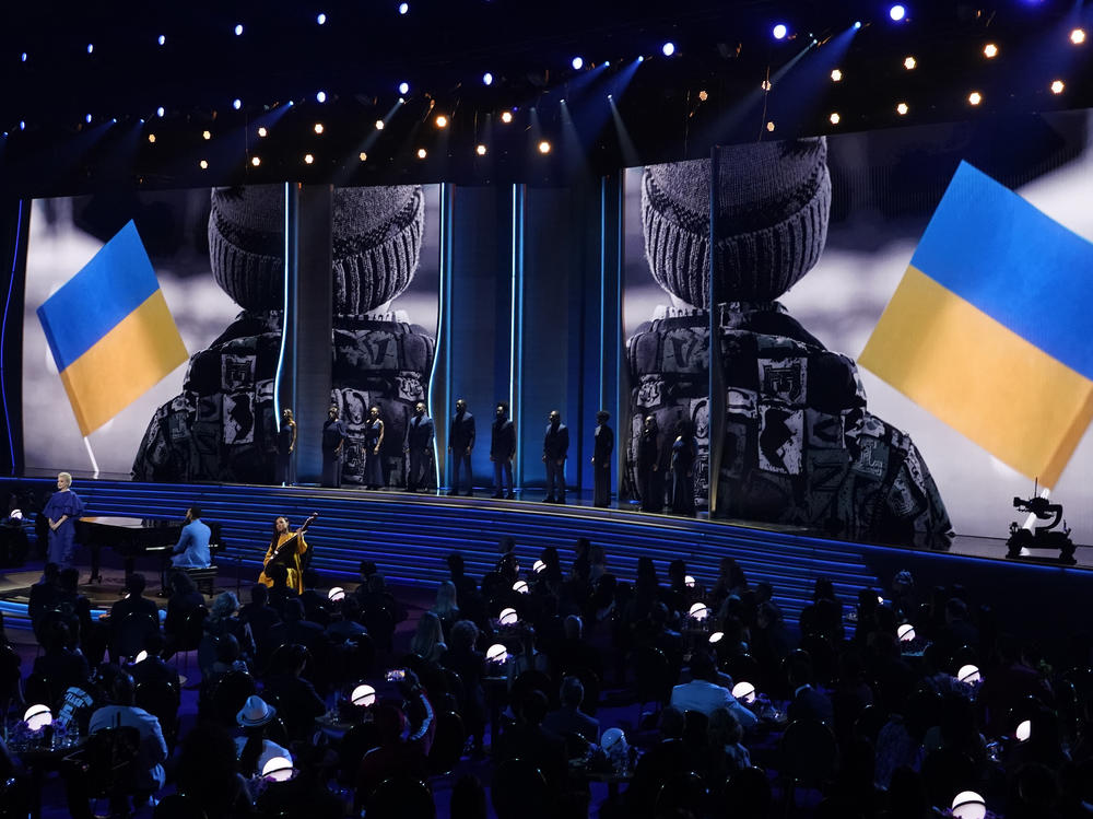Ukrainian singer Mika Newton, left, and John Legend perform 