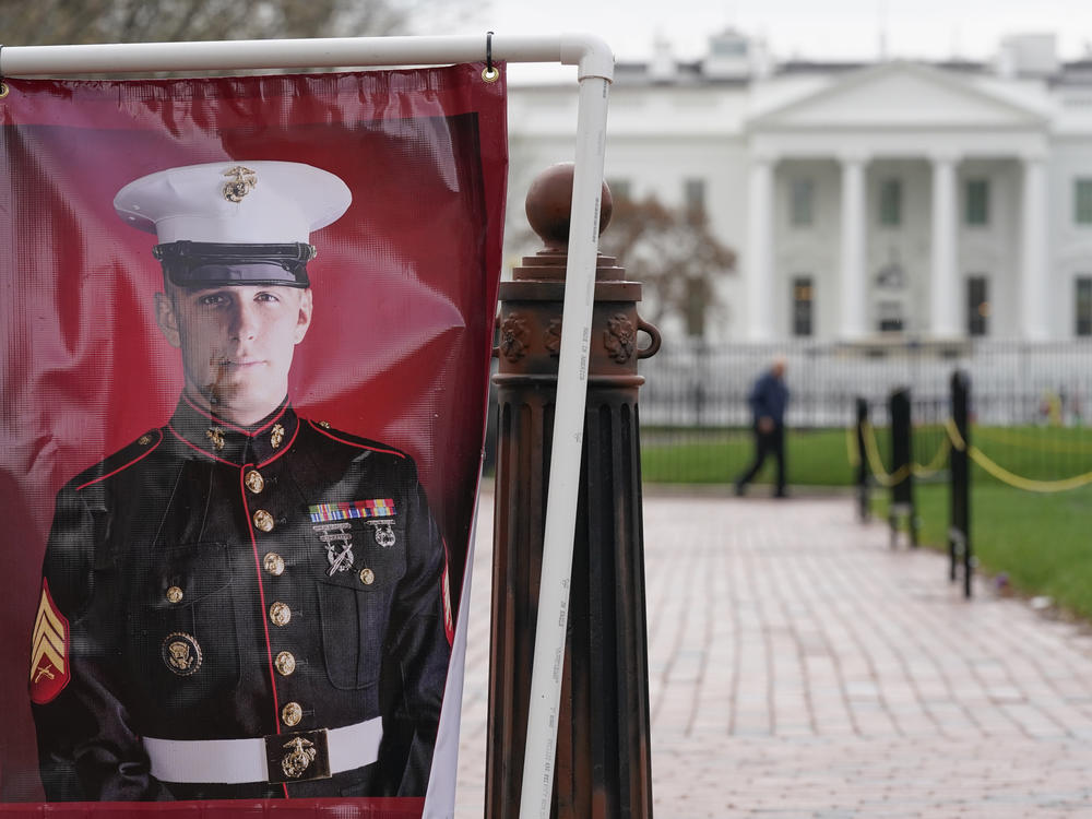 A poster photo of U.S. Marine Corps veteran and Russian prisoner Trevor Reed is hung in Lafayette Park near the White House on Wednesday.