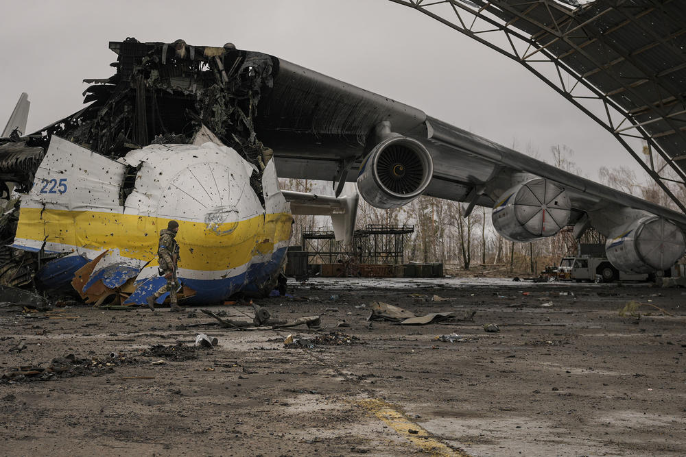 <strong>April 2:</strong> A Ukrainian serviceman walks by an Antonov An-225 Mriya aircraft destroyed during fighting between Russian and Ukrainian forces on the Antonov airport in Hostomel, Ukraine. At the entrance to the airport, Ukrainian troops manned their positions, a sign they are in full control of the runway that Russia tried to storm in the first days of the war.