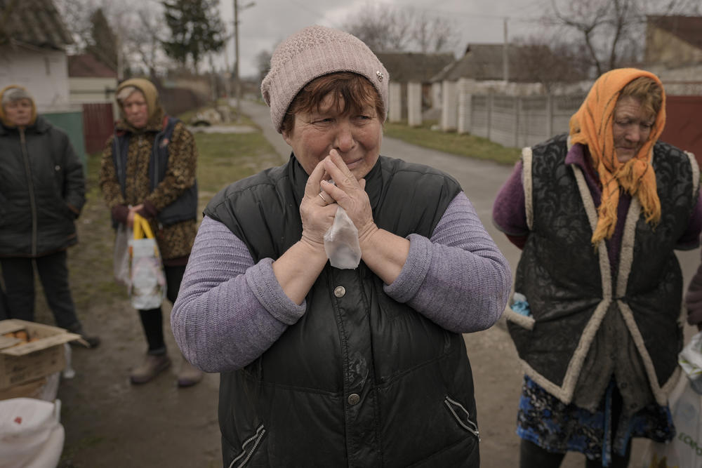 <strong>April 3:</strong> A woman cries while waiting for food in the village of Motyzhyn, which sits just west of Kyiv and was, until recently, under Russian control.