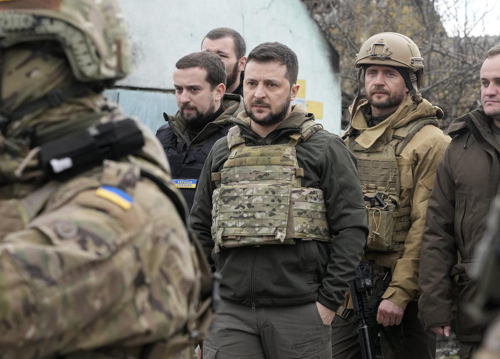 Ukrainian President Volodymyr Zelenskyy examines the site of a recent battle in Bucha on Monday. Russia is facing a fresh wave of condemnation after evidence emerged of what appeared to be deliberate killings of civilians in Ukraine.