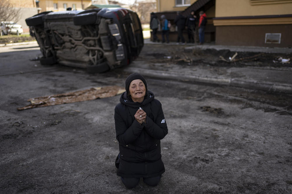 A woman mourns the death of her husband, killed in Bucha.