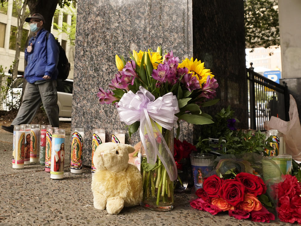 Flowers and votive candles make up a memorial near the location of Sunday's mass shooting in Sacramento, California.