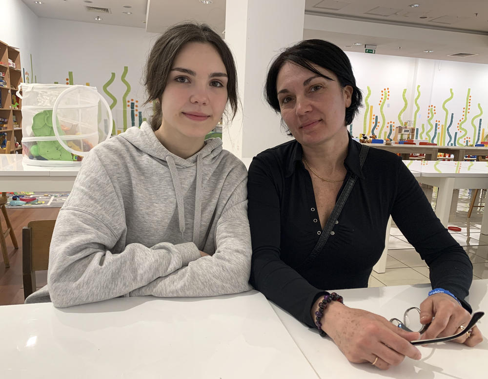 Galia Alacheva and her mother Sara Tarashchanska sit together in a pop-up lunchroom in an abandoned mall that has been converted into a shelter for Ukrainian refugees.