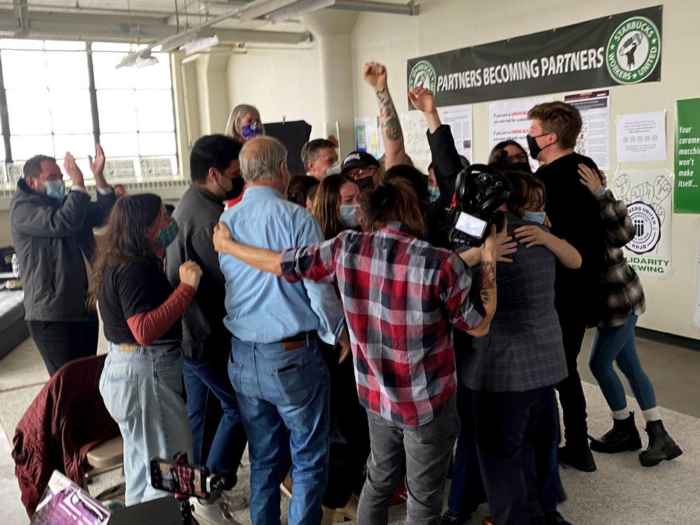 Starbucks employees celebrate after the votes to unionize are counted at one Buffalo, N.Y., location on Dec. 9, 2021.