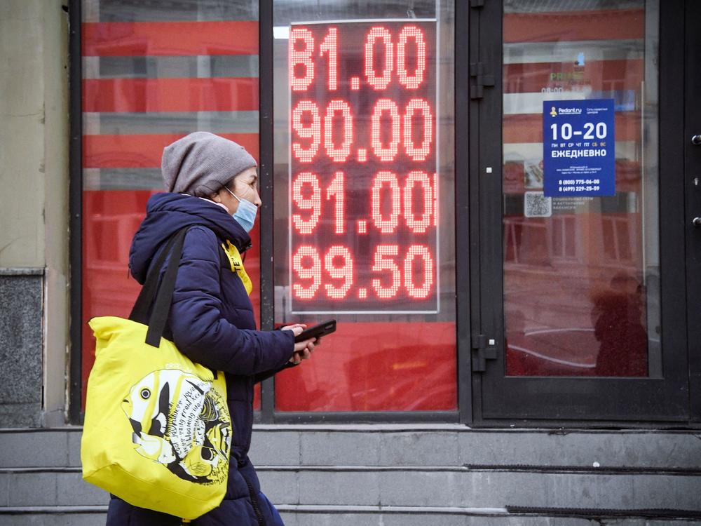 A woman walks past a currency exchange office in central Moscow on Feb. 24.