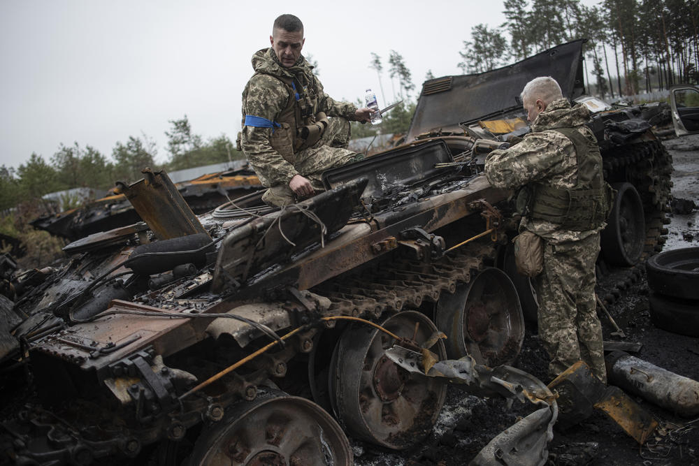 <strong>April 2:</strong> Ukrainian soldiers inspect a burnt Russian APC in Dmytrivka, in the Kyiv Oblast.