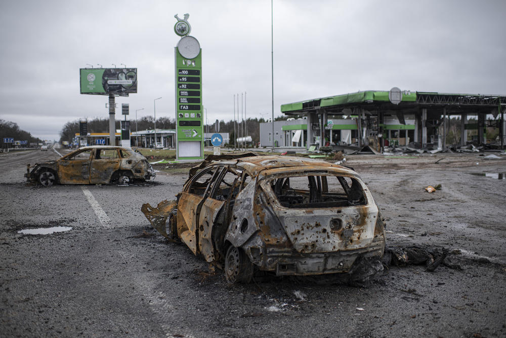 <strong>April 2:</strong> A corpse is seen by a burnt car on the road between Myla and Mriia, Kyiv region, Ukraine.