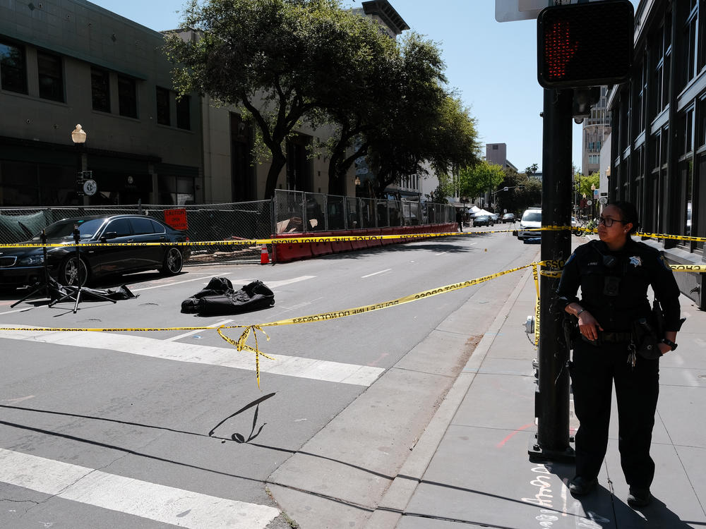 Police work the scene at the corner of 10th and J streets in Sacramento after Sunday's shooting.