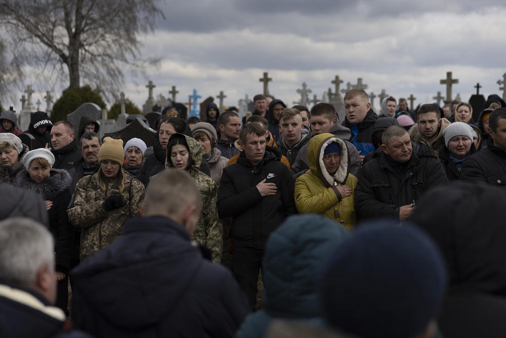 <strong>April 3:</strong> Family and friends recite the Ukrainian national anthem as they mourn Ukrainian soldier Dmitry Zhelisko during his burial in Rusyn, Ukraine. Zhelisko died fighting the Russian army near the city of Kharkiv.
