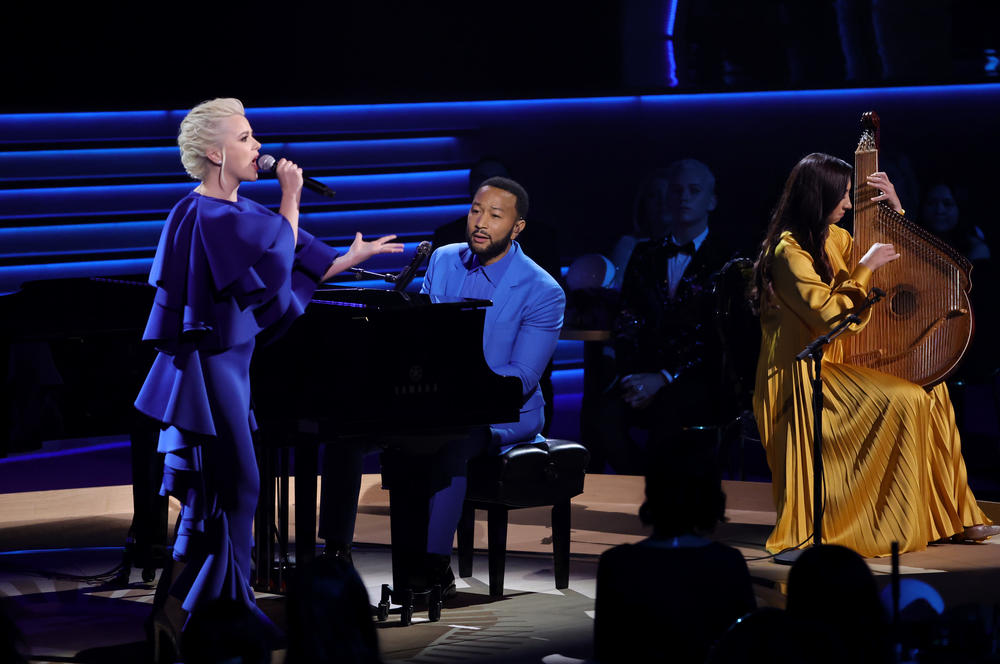 John Legend (center) performed with Ukrainian musicians Mika Newton (left) and Siuzanna Iglidan following a taped speech by Ukrainian President Volodymyr Zelenskyy during the 2022 Grammy Awards on Sunday, April 3.