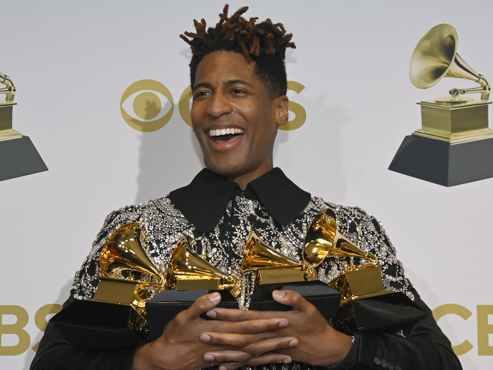 Jon Batiste poses with four of his five trophies during the 64th annual Grammy Awards.