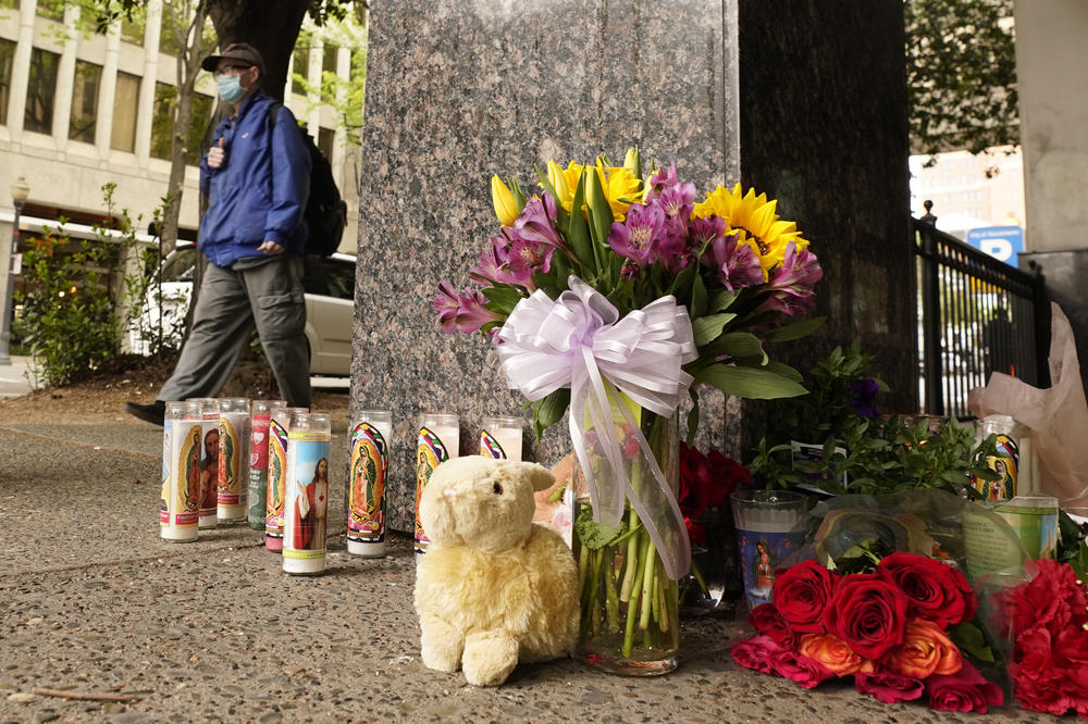 A person passes a memorial near the location of a mass shooting in Sacramento, Calif., on Monday. Multiple people were killed and injured in the shooting a day earlier.