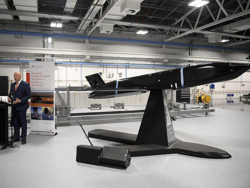 Australia's Defence Minister Peter Dutton stand next to an anti-ship missile as he addresses industry representatives during the opening of the Navy Guided Weapons Maintenance Facility, in Sydney, on Tuesday.