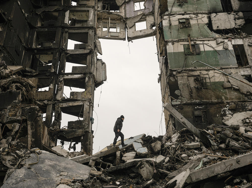 A resident looks for belongings on Tuesday in an apartment building destroyed during fighting between Ukrainian and Russian forces in Borodyanka, Ukraine.