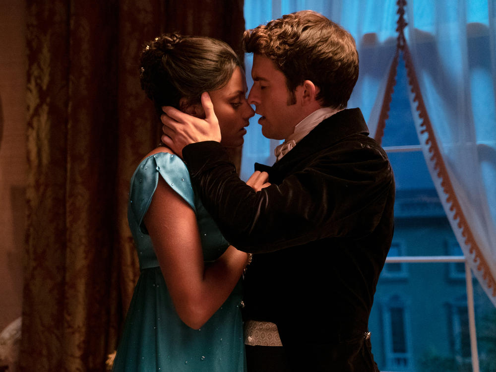 Simone Ashley (as Kate Sharma) shares an intimate moment with Jonathan Bailey (as Anthony Bridgerton). Twitter commenters in India have expressed joy at seeing a dark-skinned Indian woman in the cast while Bollywood films often feature lighter-skinned Indian actors.