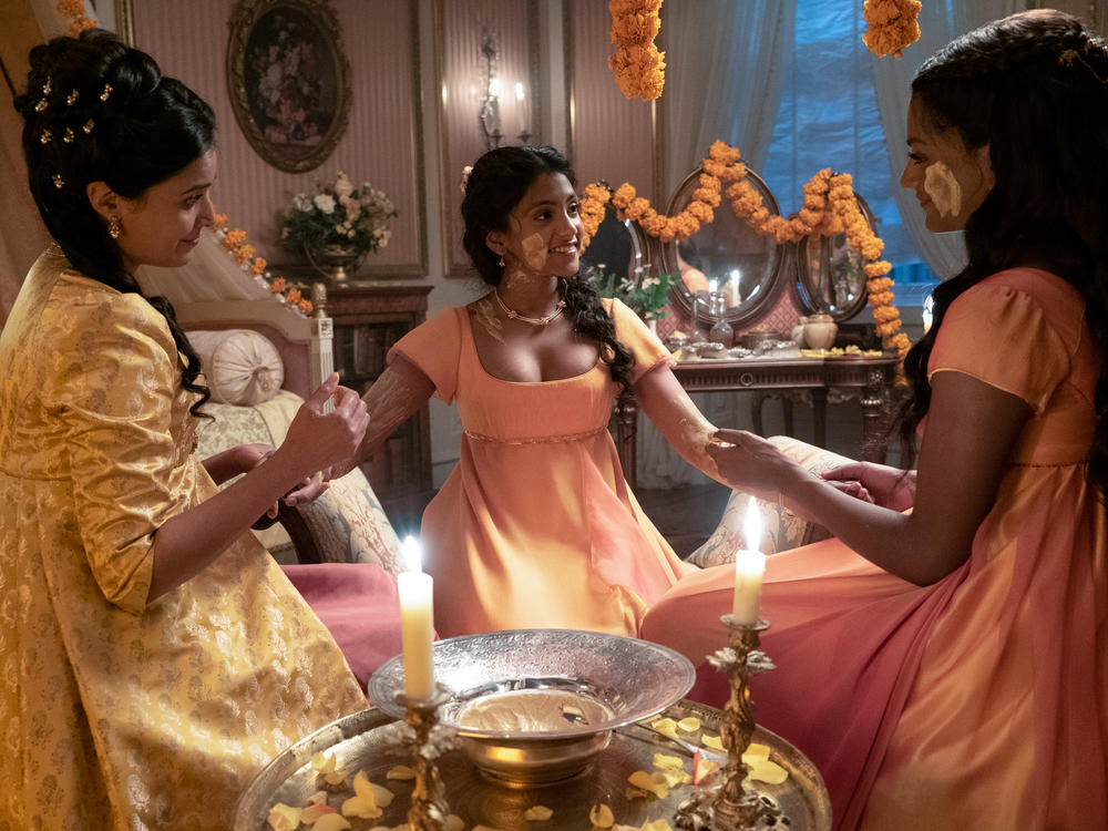 Mary Sharma (Shelley Conn) eloped with an Indian tradesman and left her native England. Now she's back, a widow hoping to find support from her estranged family — and a husband for daughter Edwina (center). The show's depiction of Indian fashion has earned praise although fans are quick to point out cultural inaccuracies.