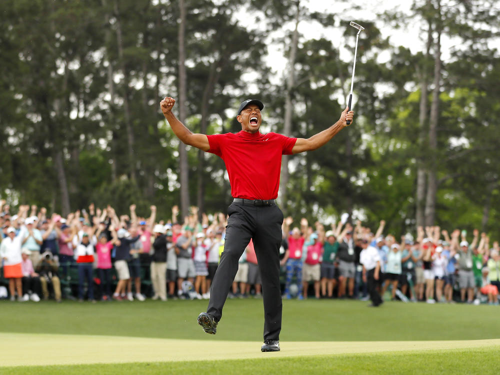 Tiger Woods celebrates after sinking his putt on the 18th green to win the Masters Tournament on April 14, 2019, in Augusta, Ga.
