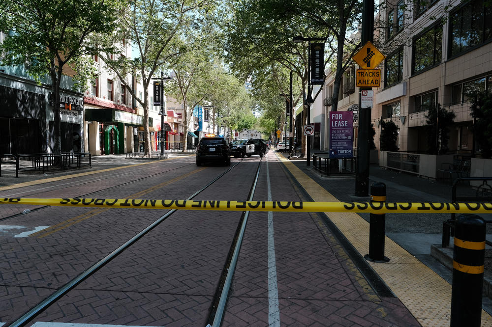 Police work the scene on the corner of 9th and K street after a shooting that occurred in the early morning hours on Sunday in Sacramento, Calif.