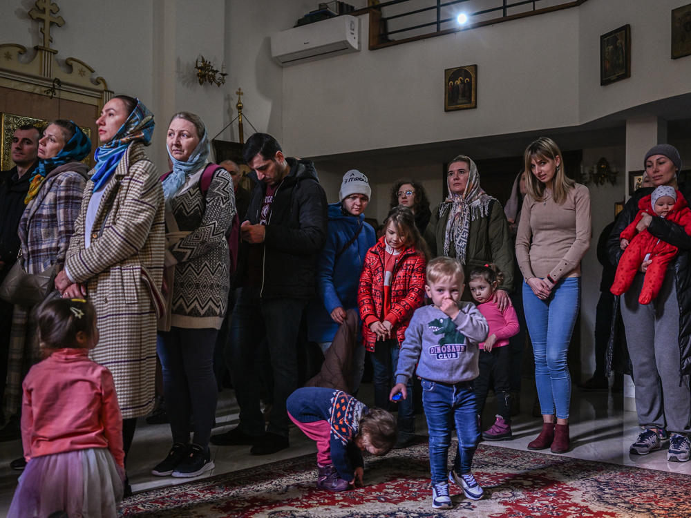 People who fled the war in Ukraine and members of the Ukrainian diaspora pray in an Orthodox church in Krakow on Sunday.