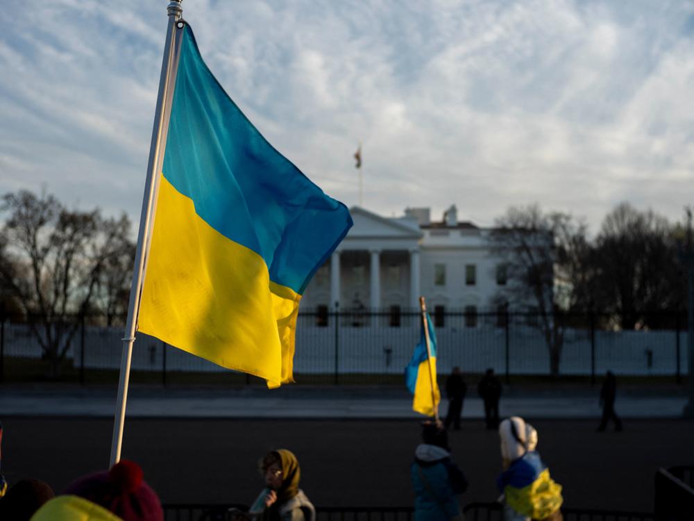 Activists hold Ukrainian flags as they protest against Russia's invasion of Ukraine during a rally at Lafayette Square, across from the White House, in Washington, D.C., on Feb. 25. New U.S. sanctions Sanctions are being enacted on top Russian officials and family members, including President Vladimir Putin's adult children.