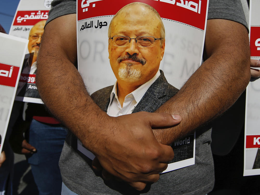 People hold posters of slain Saudi journalist Jamal Khashoggi near the Saudi Arabia consulate in Istanbul, Oct. 2, 2020, marking the two-year anniversary of his death.