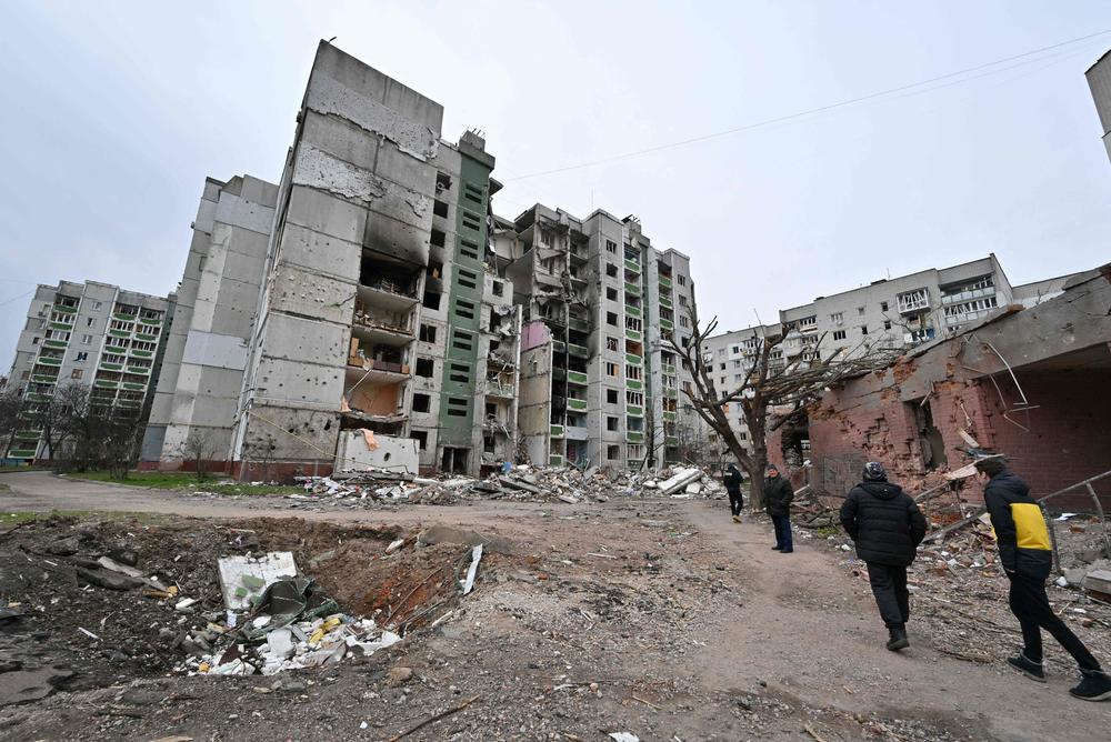 People pass a crater in the city of Chernihiv, which was heavily shelled by the Russians. The photo was taken on April 5.