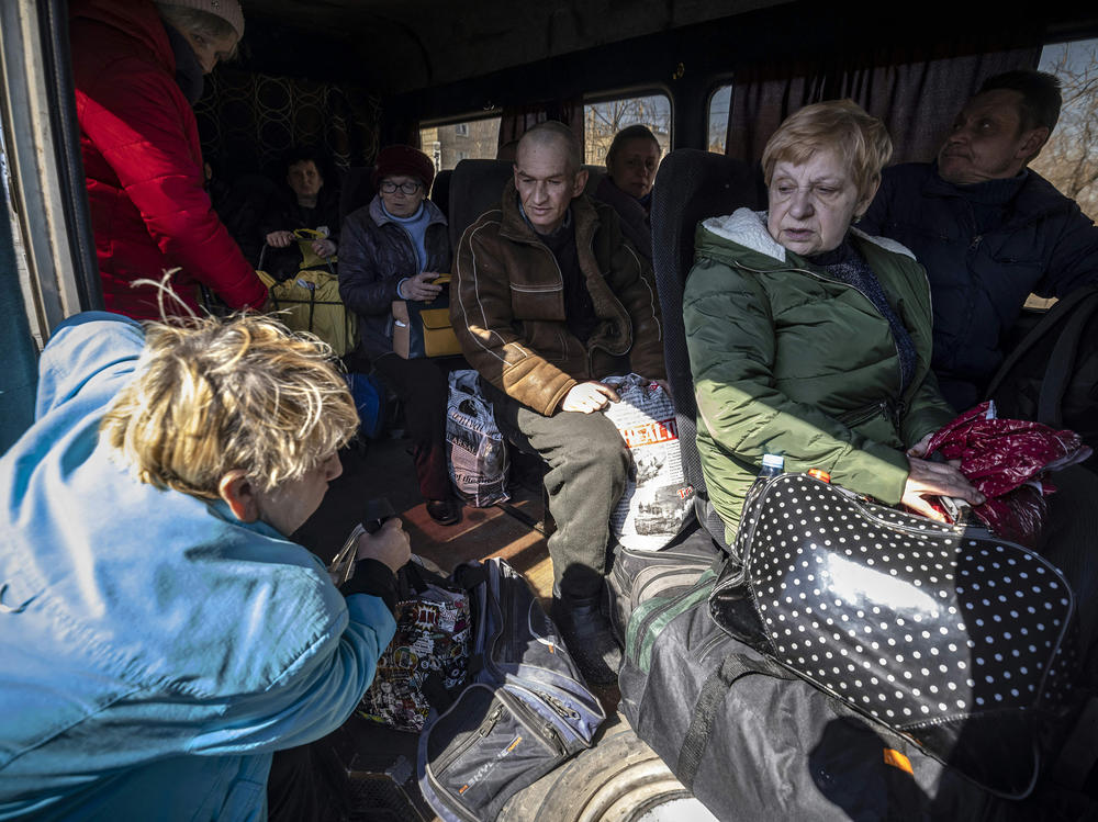 People crowd into a bus on Thursday on their way to a train station in Severodonetsk, as they try to flee eastern Ukraine.