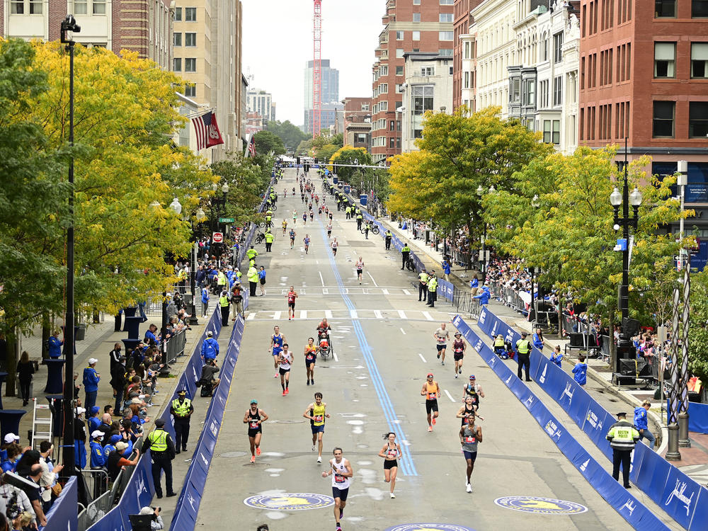 Runners near the finish line on Boylston Street during the 125th Boston Marathon on October 11, 2021 in Boston, Massachusetts. Runners residing in Russia and Belarus are banned from this year's event.