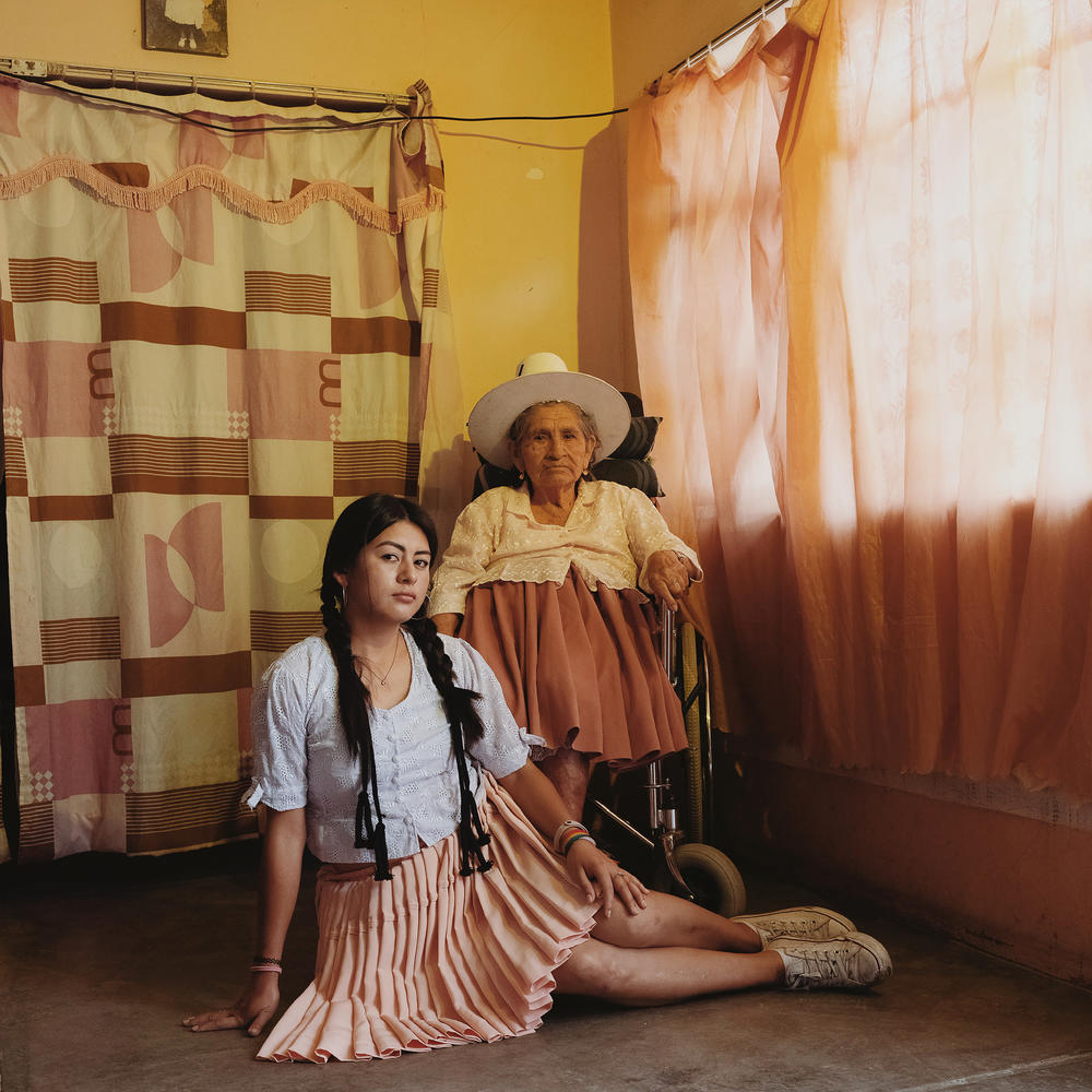 Skater Luisa Zurita, 32, wears her grandmother's traditional <em>pollera</em> skirt while her grandmother styles her hair. 