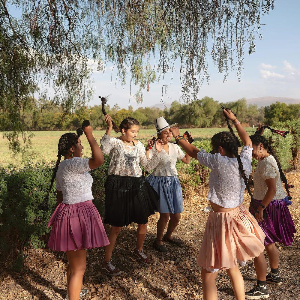 The girls dance at Pairumani Park on the outskirts of Cochabamba. 