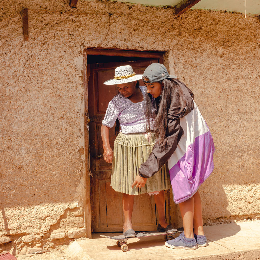 Skater Huara Medina Montaño, 24, teaches a fellow skater's mother how to ride a skateboard.