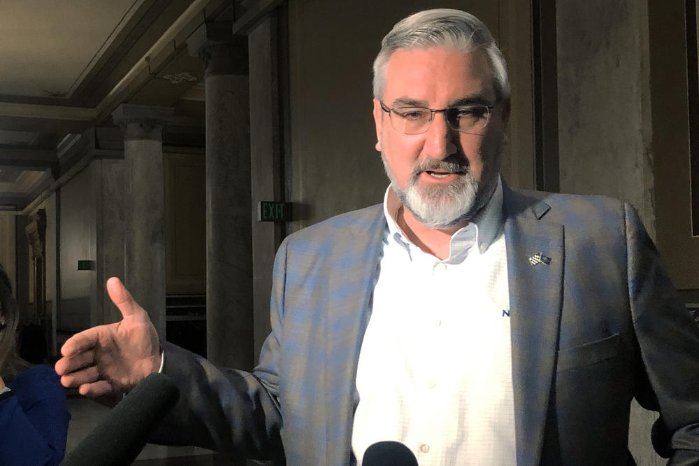 Indiana Gov. Eric Holcomb speaks with reporters at the Indiana Statehouse in Indianapolis Feb. 23, 2022. Gov. Holcomb is facing criticism from many fellow Republicans for his veto on legislation banning transgender females from competing in girls school sports.