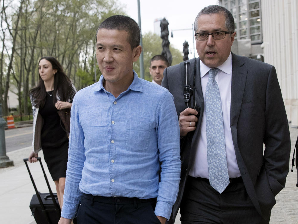 Former Goldman Sachs executive Roger Ng (center) leaves Brooklyn federal court with attorney Marc Agnifilo on May 6, 2019, in New York. On Friday, Ng was convicted of bribery and other corruption charges accusing him of participating in a $4.5 billion scheme to ransack the Malaysian state investment fund.