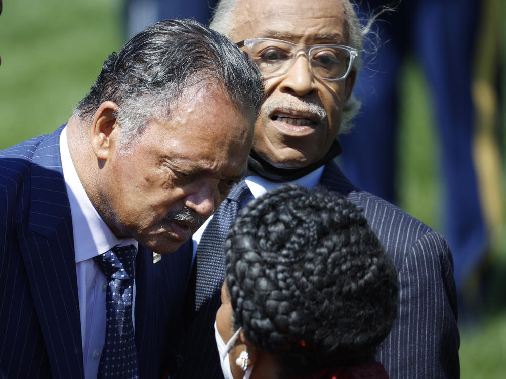 Civil rights leaders Revs. Jesse Jackson (center) and Al Sharpton (right) arrive at the White House for Friday's event celebrating Judge Ketanji Brown Jackson's confirmation to the Supreme Court.
