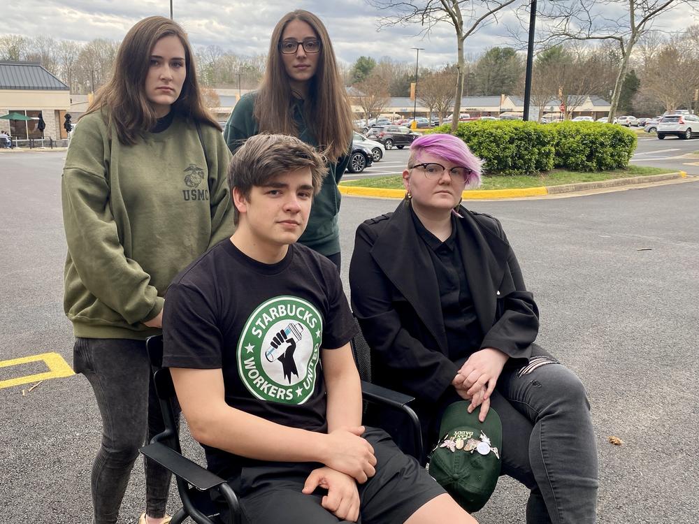 Clockwise from top left: Claire Picciano, Megan Gaydos, Gailyn Berg, and Tim Swicord pose for a photo in the parking lot outside their Starbucks store in Springfield, Virginia, on March 25, 2022.