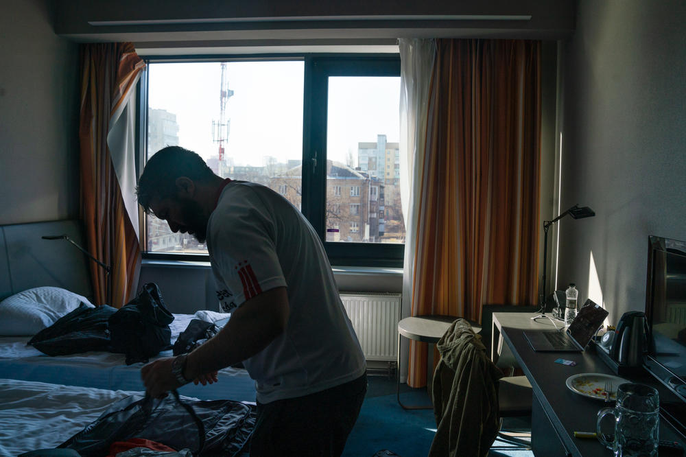 Preparing to go on a dangerous rescue mission to a Kyiv suburb to rescue U.S. Army veteran Bob Platt and his Ukrainian wife, Stern organizes and packs his bags in his hotel room.