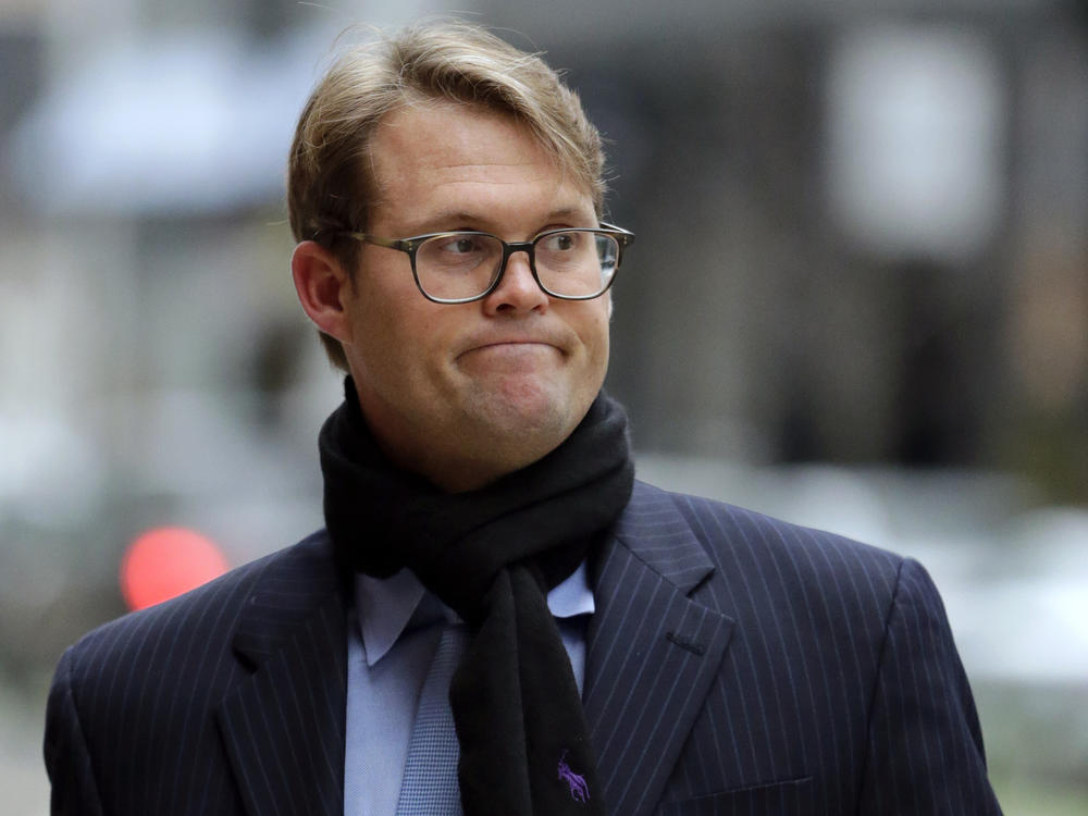 Mark Riddell arrives at federal court in Boston on April 12, 2019. The former Florida prep school administrator took college entrance exams for students in exchange for cash to help wealthy parents get their kids into elite universities.