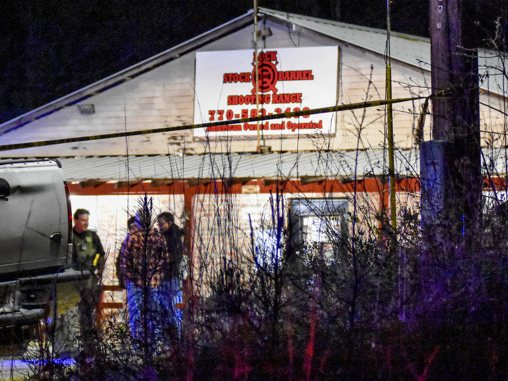 Law enforcement agents investigate the scene of a fatal robbery at Lock Stock & Barrel Shooting Range late Friday, April 8, 2022 in Coweta County, Ga., about 50 miles southwest of Atlanta.