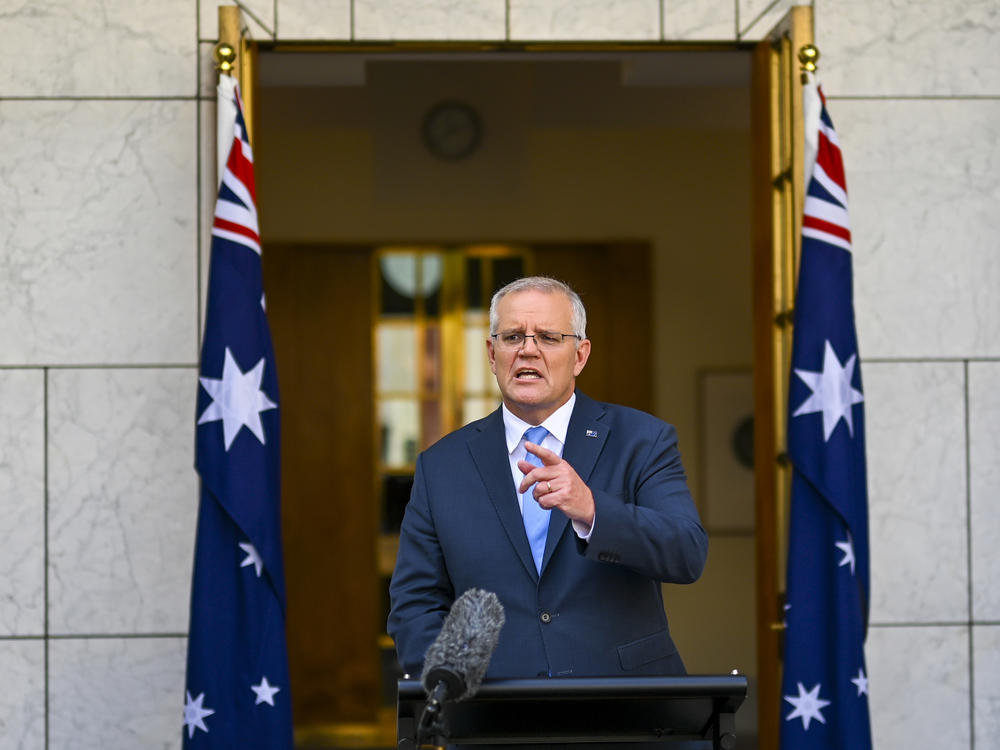 Australian Prime Minister Scott Morrison gestures during a news conference at Parliament House in Canberra, Australia, Sunday, April 10, 2022.