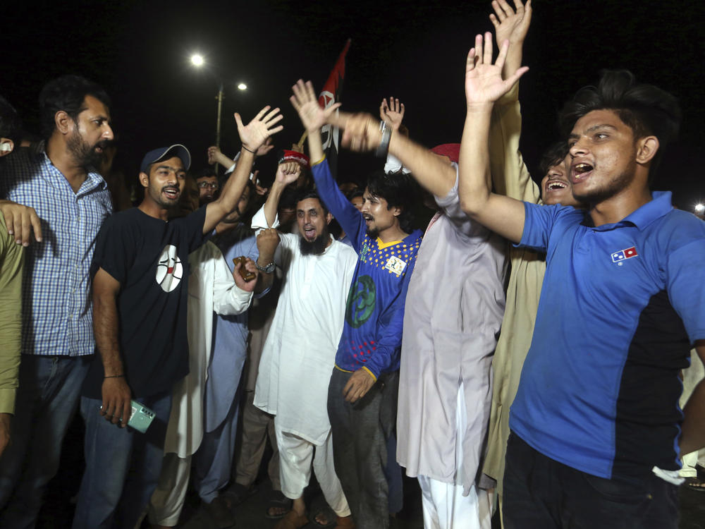 Supporters of an opposition party celebrate the success of a no-confidence vote against Prime Minister Imran Khan, in Karachi, Pakistan on Sunday.