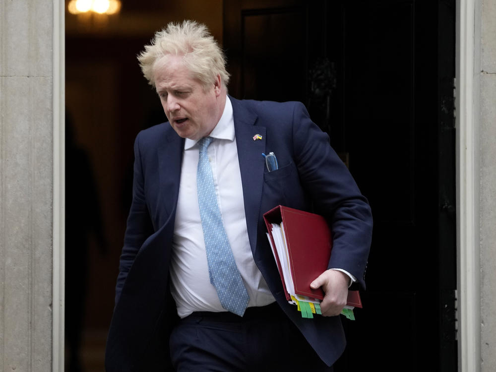 Prime Minister Boris Johnson leaves 10 Downing Street to attend the weekly Prime Ministers' Questions session in parliament in London, on March 30. Johnson's office says he will be issued a fine for breaching COVID-19 regulations following allegations of lockdown parties at government offices.