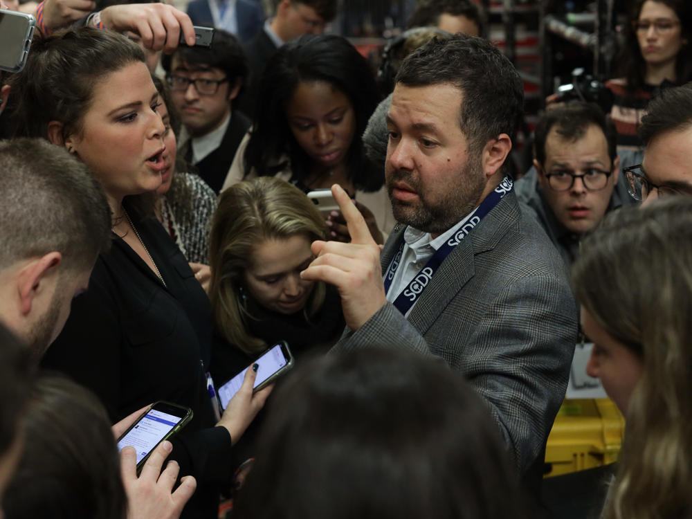 Chaos reigned in Des Moines, Iowa, on Feb. 3, 2020, as reporters pressed various campaign and election officials for why the caucus results were so delayed.