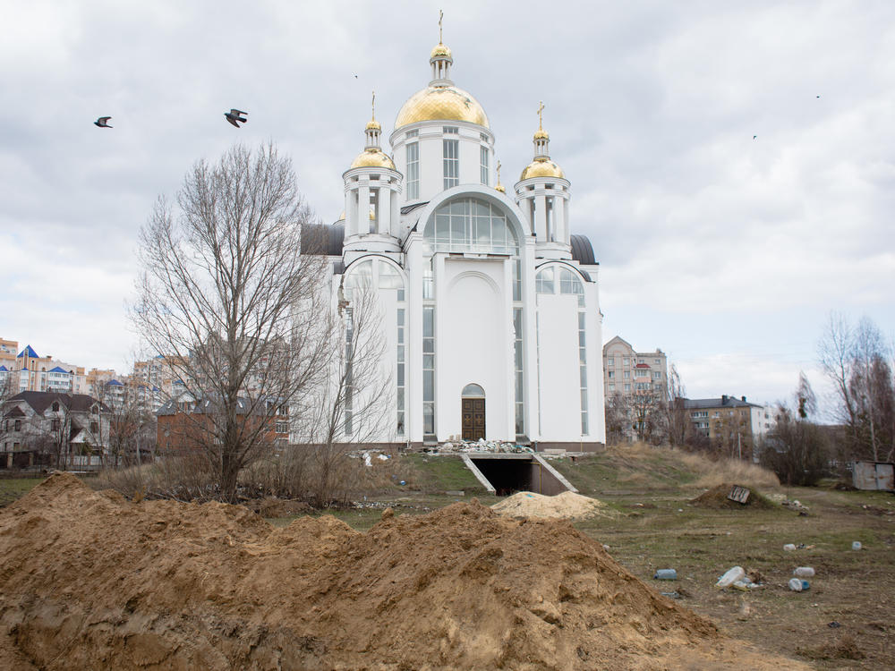 A view of a mass grave by a church on April 4 in Bucha, Ukraine.