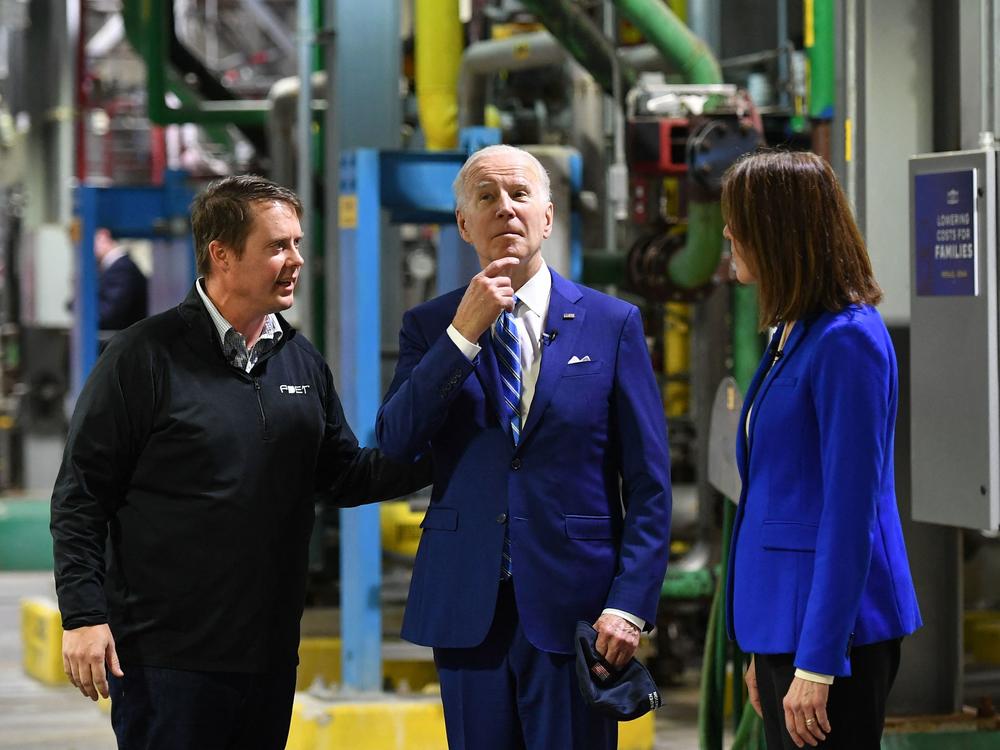 President Biden speaks with Democratic Rep. Cindy Axne of Iowa, right, and Jack Mitchell, regional vice president of POET Bioprocessing during a visit to its plant in Menlo, Iowa, where he announced the EPA would ease restrictions on fuel containing E15 ethanol.