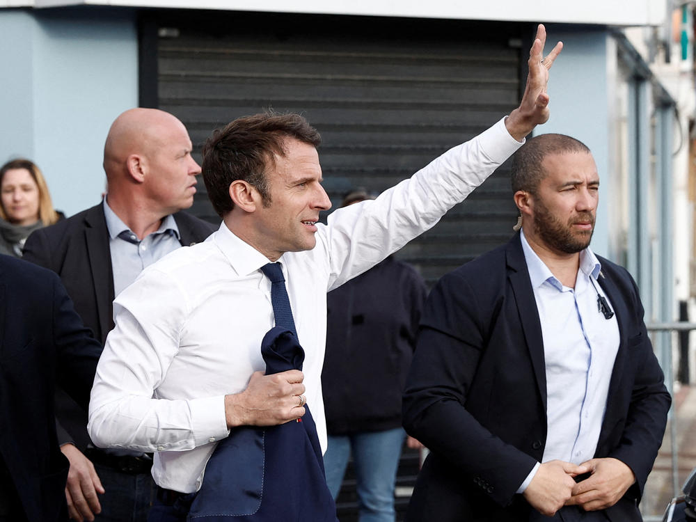 France's President and French liberal party La Republique en Marche (LREM) candidate to his succession Emmanuel Macron waves to supporters during a one-day campaign visit in Hauts-de-France region, in Carvin, northern France, on Monday.