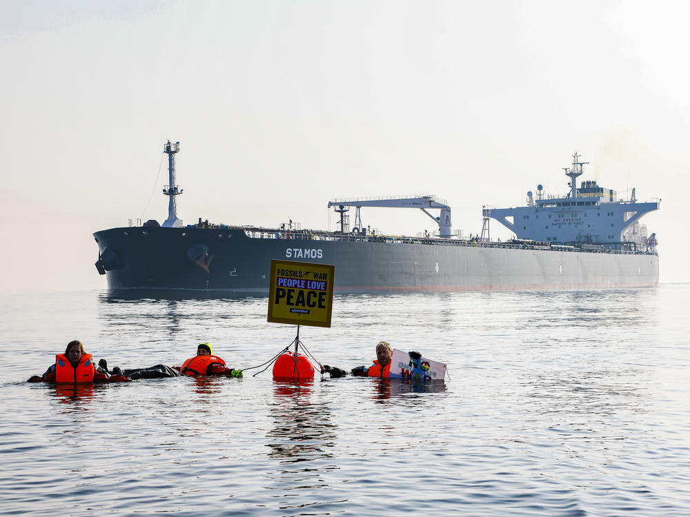 Activists demonstrate in front of a ship carrying Russian oil in the Baltic Sea this spring. The U.S. has imposed sanctions on Russian oil. However, most countries have not, and refineries around the world still import Russian oil.