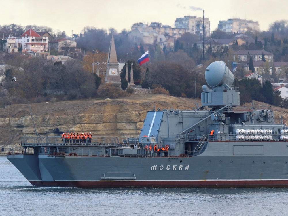 Russian navy officers line up on the deck as the guided missile cruiser Moskva (Moscow) sailed into a harbor after tracking NATO warships in the Black Sea, in the port of Sevastopol, Crimea, Nov. 16, 2021. Russian authorities said the Moskva sank Thursday.