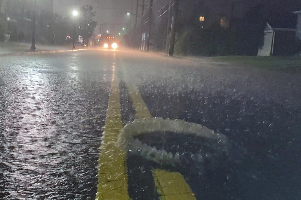 A utility hole cover bubbles open in a road flooded by the remnants of Hurricane Ida. Across the U.S., millions of miles of pipes and stormwater infrastructure stretch below city streets. Most are decades-old, designed for the storms of last century.