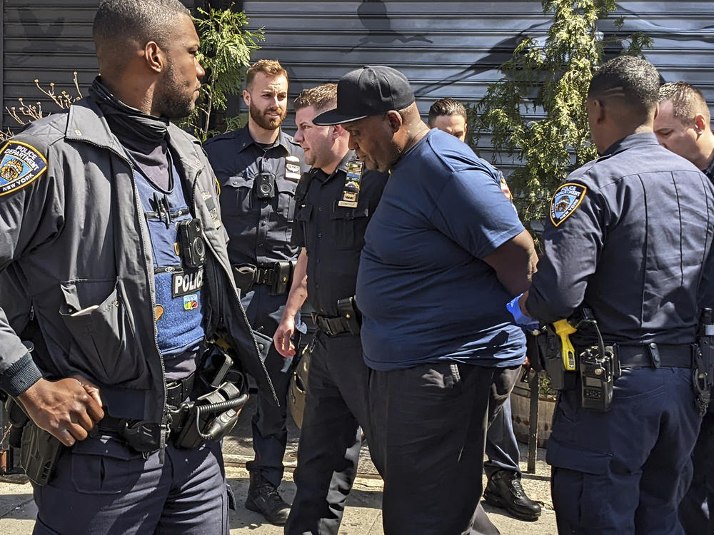 New York City Police Department officers handcuff subway shooting suspect Frank R. James, 62, in the East Village section, of New York, Wednesday, April 13, 2022.